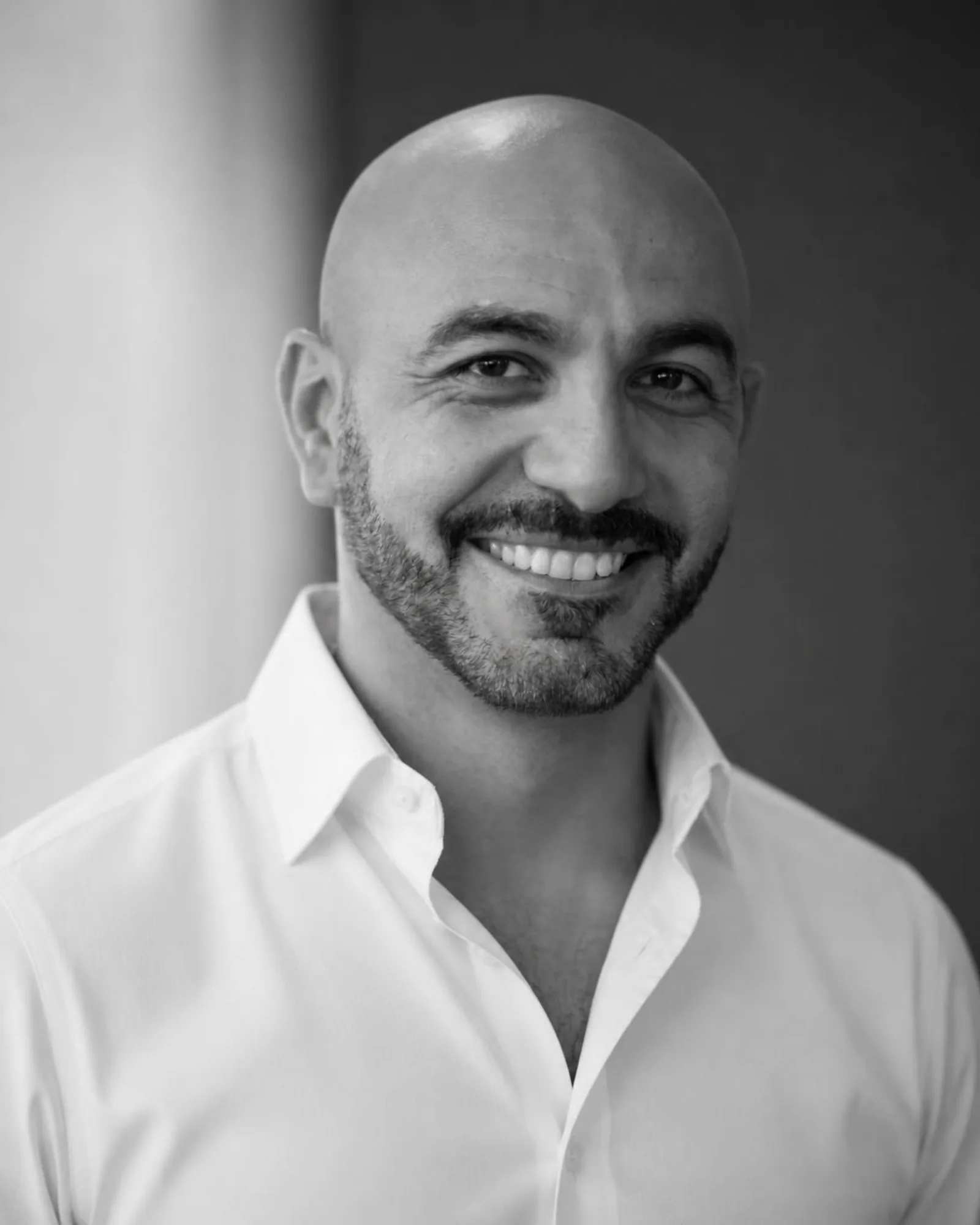 Joe Mikhail, smiling, black and white portrait